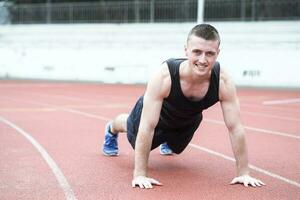 Handsome fit man exercising push up photo