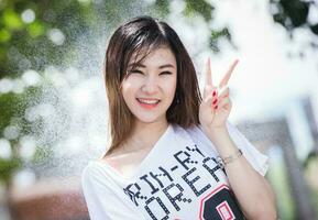 contento chino niña es consiguiendo mojado y lluvia foto