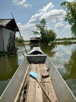 wooden boat in village swamp photo