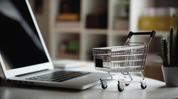 E-commerce concept. Shopping cart with boxes on a wooden table. photo