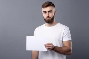 A man holds a blank white sign board mockup in his hand photo