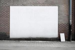 A blank white billboard mockup on a sidewalk in a city photo