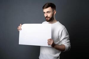 A man holds a blank white sign board mockup in his hand photo