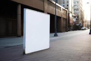 A blank white billboard mockup on a sidewalk in a city photo