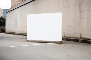 A blank white billboard mockup on a sidewalk in a city photo