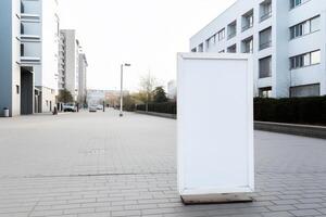 A blank white billboard mockup on a sidewalk in a city photo