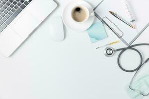 Top view of doctor desk table with stethoscope photo