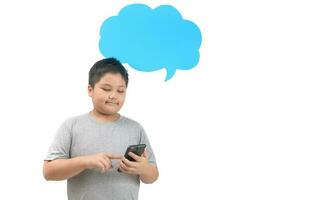 Obese boy play smartphone with empty blue speech bubble isolated photo