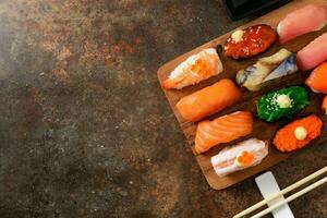close up of sashimi sushi set with chopsticks photo