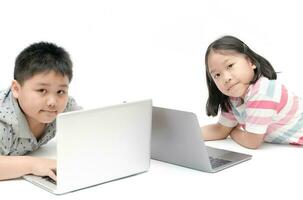 cute sister and young brother play laptop photo