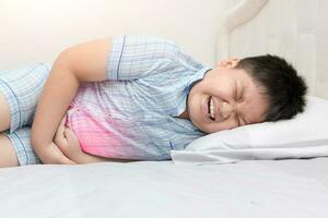 asian fat child suffering from stomachache photo