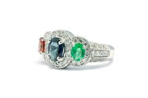 Closed up Emerald, Blue Sapphire and Pink Diamond with white diamond and Platinum ring photo