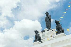 Black Big Buddha statue with white cloudy and blue sky photo