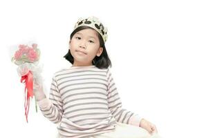 Cute asian girl wearing a crown and holding rose bouquet photo