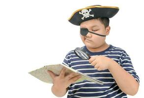 Kid pirate using magnifying glass to view the map photo