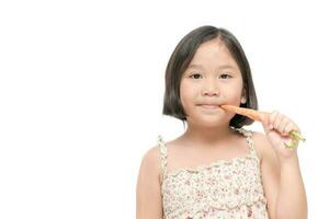 cute asian girl eat baby carrot isolated on white background. photo