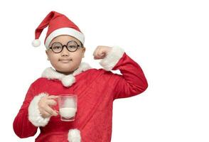 Obese fat boy in santa claus suit holding milk glass photo