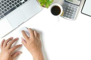 White office desk table with hand man using mouse with laptop isolated photo