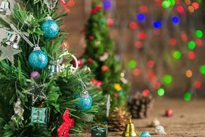 closed up of Christmas tree with gift on old wood photo