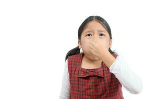 Asian girl holding her nose because of a bad smell isolated photo