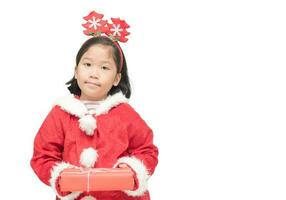 Cute asian girl in santa claus suit holding gift box photo