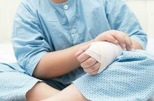 kid with broken hand and elastic bandage photo