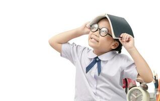 Smart little Asian girl thinking with book on head photo