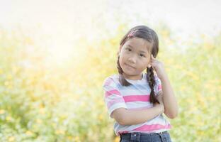 cute asian little girl thinking on nature photo