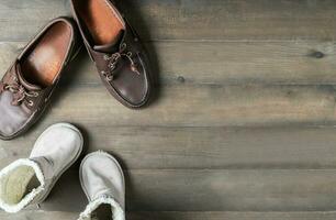 Father and son brown leather boots shoes on wooden photo