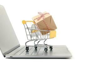 Boxes in a trolley on a laptop keyboard isolated photo