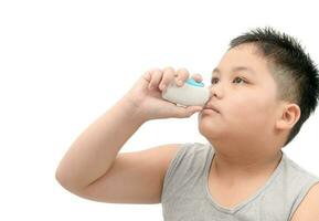 boy spraying medicine in nose against flu or sinus photo