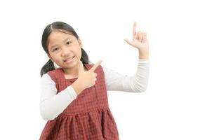 Asian cute girl pointing at empty space isolated on white. photo