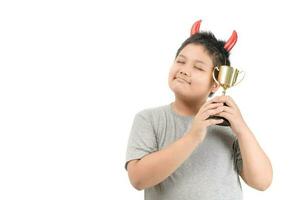 Obese fat child holding golden winning cup photo