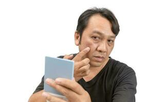 Man applying cream onto face with melasma photo