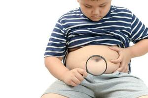 Obese boy overweight  holding magnifying glass photo