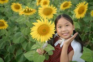 Happy cute asian girl smile with sunflower, photo