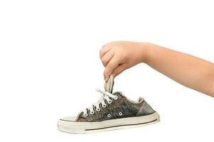 Child Holding An Old Dirty and Smelly Sneaker photo