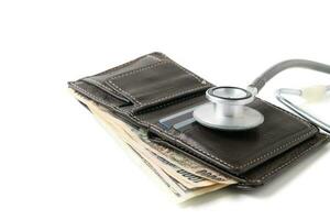 Stethoscope on wallet isolated on white background. photo