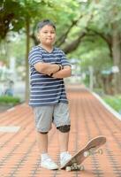 Obese boy stand on skate board photo