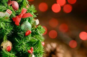 Chrismas tree with gift and red light bokeh photo