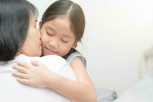 mother hugging and kiss her daughter. photo