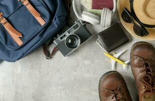 prepare backpack accessories and travel items on marble photo