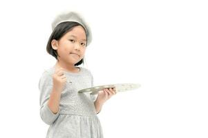 Cute asian little girl painter posing with a brush and palette. photo