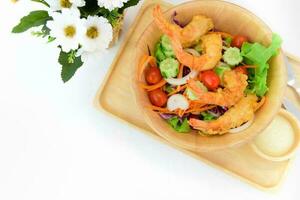 Fried shrimp salad on white table photo