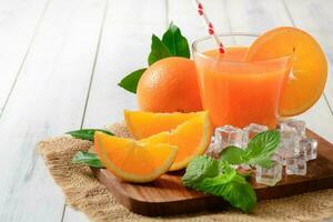 Orange juice on wood background, photo