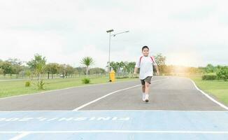 Obese fat boy walking to the finished line. photo