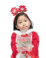 cute girl in santa claus suit holding rose bouquet photo