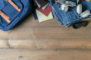 prepare backpack accessories and travel items on wood photo