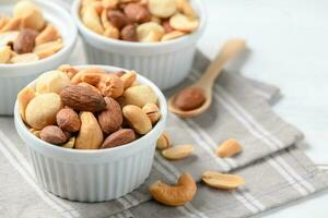 salted cocktail nuts on white wood photo