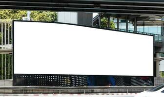 Outdoor LED curve display wall billboard with mock up white screen at crossroad. clipping path for mockup photo